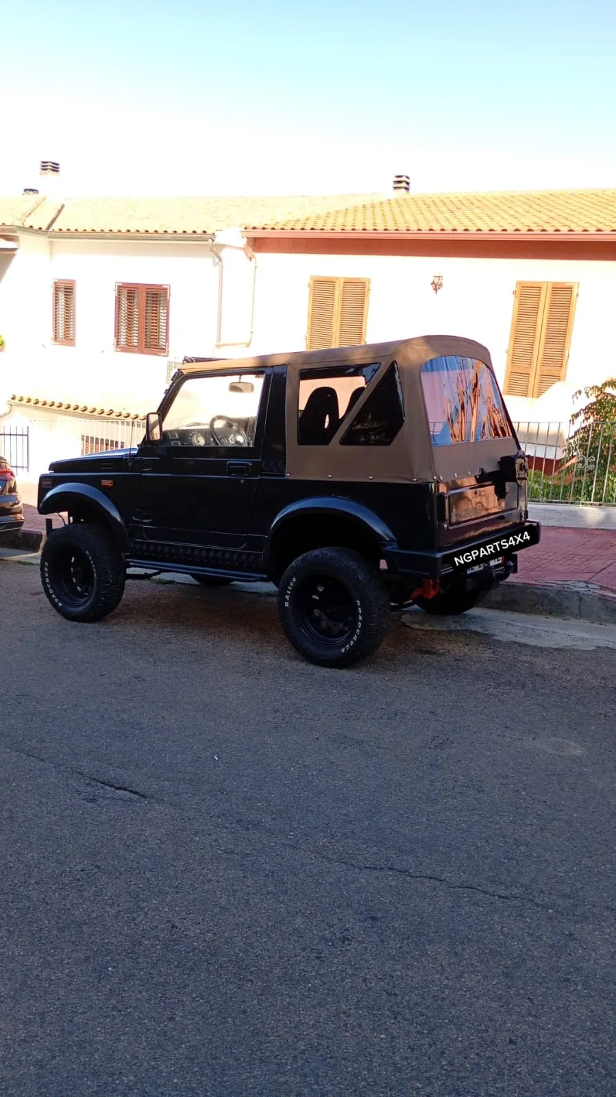 Suzuki Samurai nero con capote beige e cerchi neri